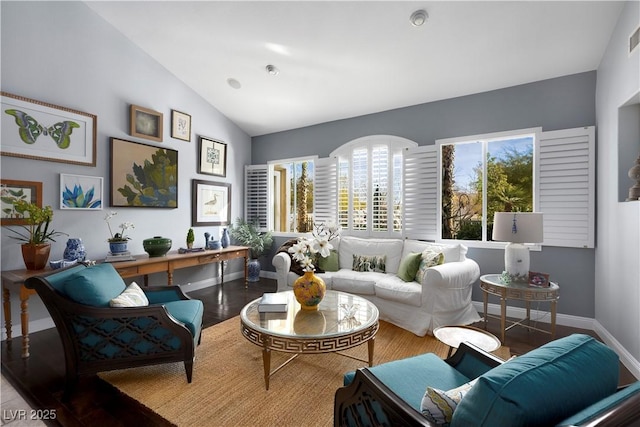 interior space with lofted ceiling, wood finished floors, visible vents, and baseboards