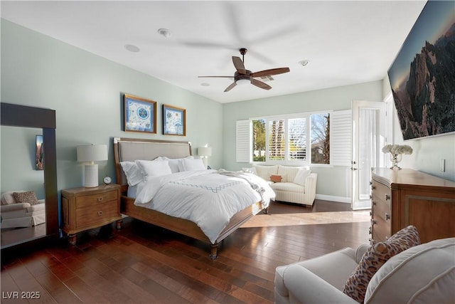 bedroom with baseboards, dark wood finished floors, and a ceiling fan