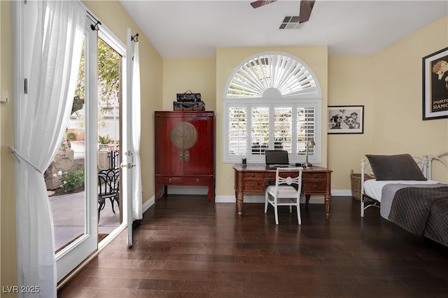 office area featuring dark wood-style flooring, plenty of natural light, visible vents, and baseboards