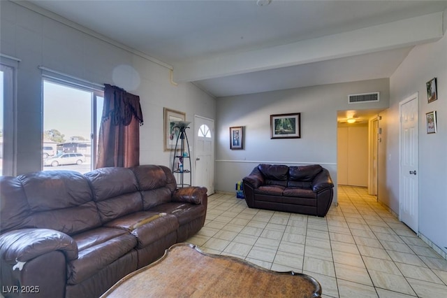 living area featuring light tile patterned floors, visible vents, and beamed ceiling