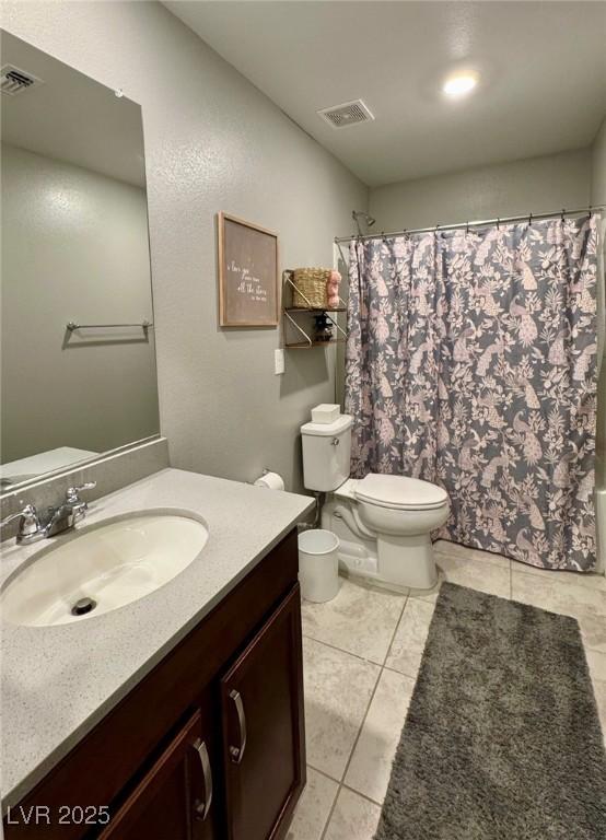 full bath with visible vents, vanity, toilet, and tile patterned floors