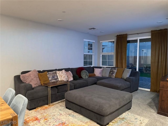 living area with carpet floors and visible vents