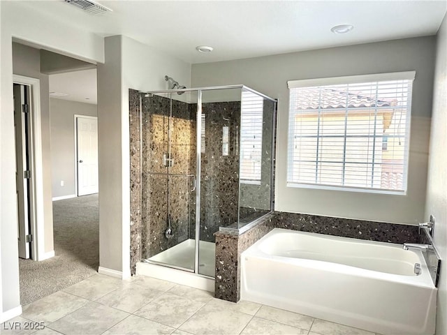 bathroom featuring a shower stall, a bath, visible vents, and tile patterned flooring