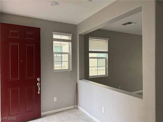 foyer featuring visible vents, tile patterned flooring, and baseboards