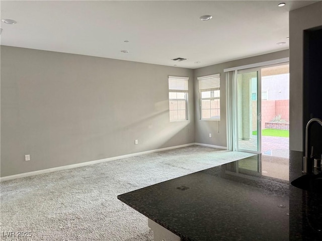empty room with recessed lighting, carpet floors, visible vents, and baseboards
