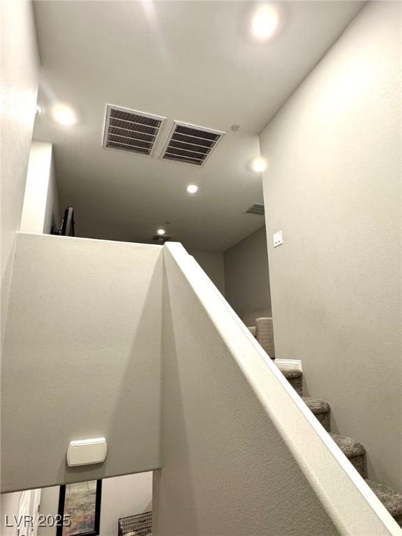 staircase featuring recessed lighting and visible vents