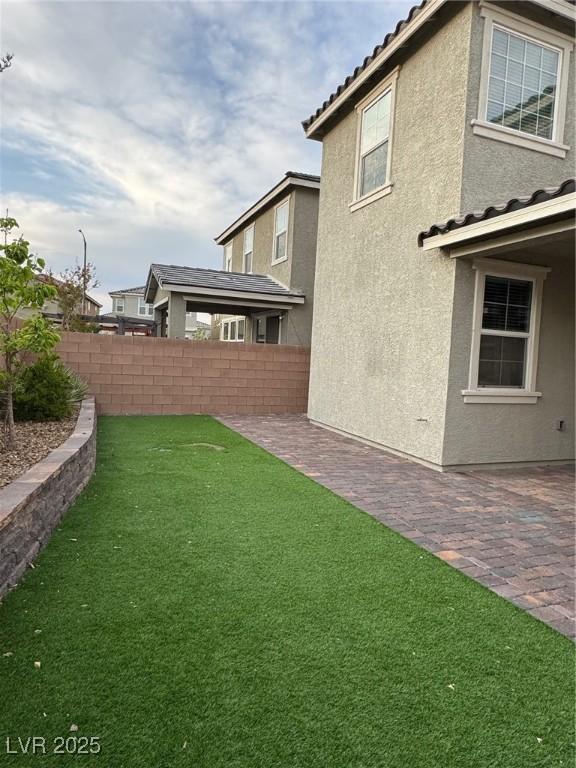 view of yard with fence and a patio area
