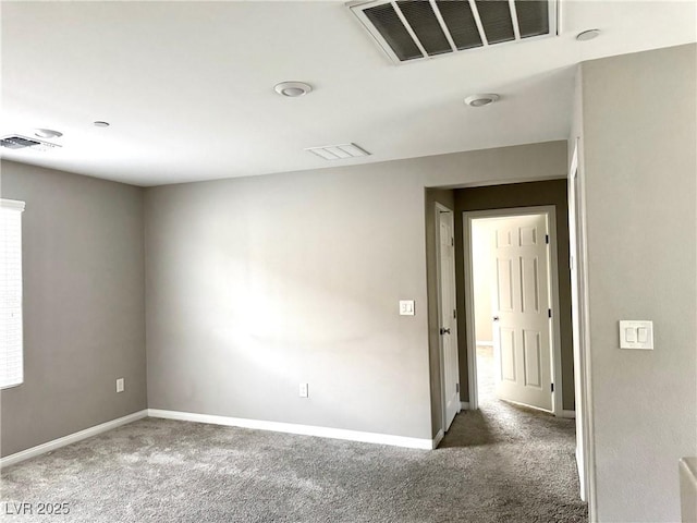 empty room featuring baseboards, carpet flooring, and visible vents