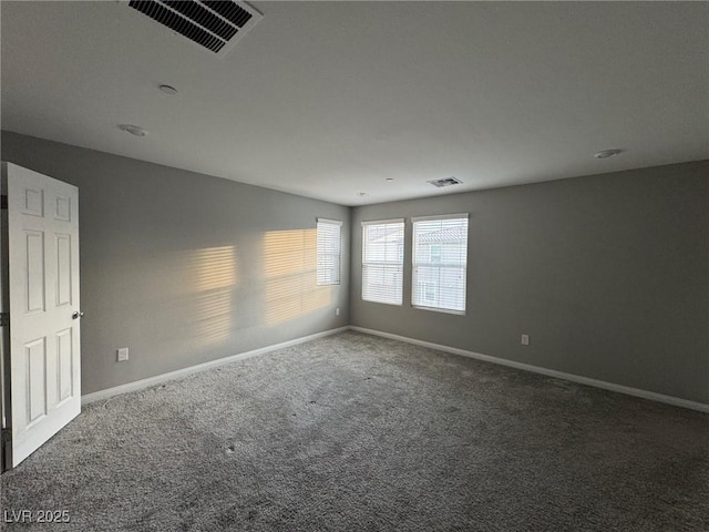 carpeted empty room with baseboards and visible vents