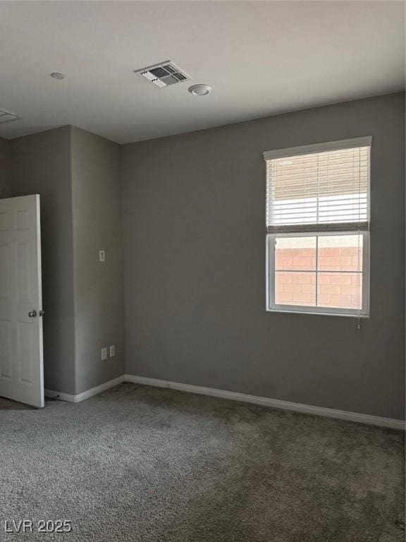 carpeted empty room with baseboards and visible vents