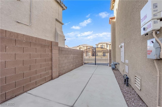 view of patio with a gate and fence