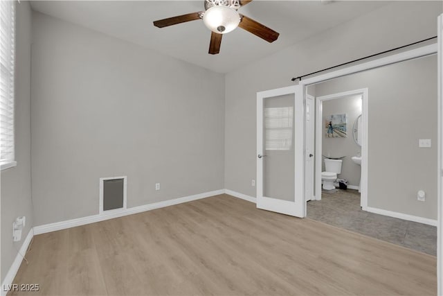 unfurnished bedroom featuring light wood finished floors, baseboards, and visible vents