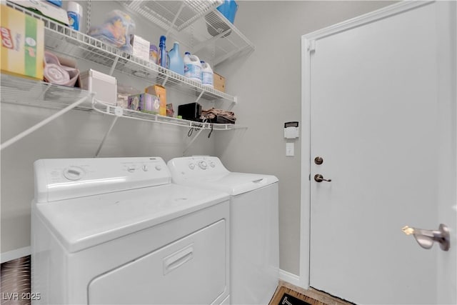 washroom with laundry area, baseboards, and washer and clothes dryer