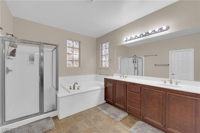 bathroom featuring a garden tub, double vanity, a stall shower, a sink, and tile patterned flooring