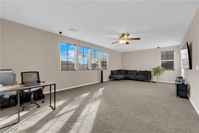 office space with carpet floors, visible vents, baseboards, and a ceiling fan