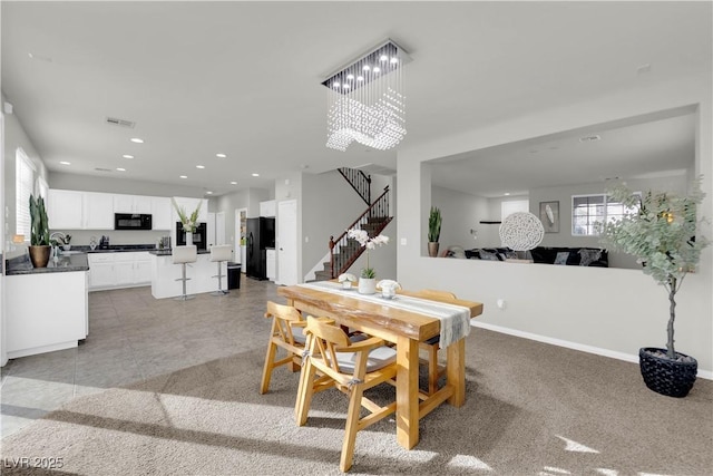 dining area with a chandelier, recessed lighting, visible vents, baseboards, and stairs