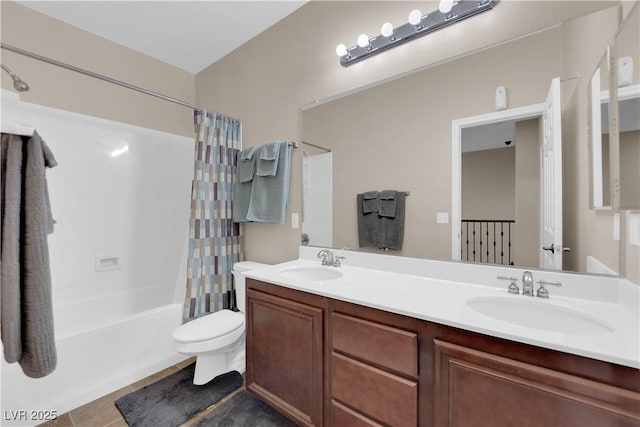 full bathroom featuring double vanity, shower / tub combo, tile patterned flooring, and a sink