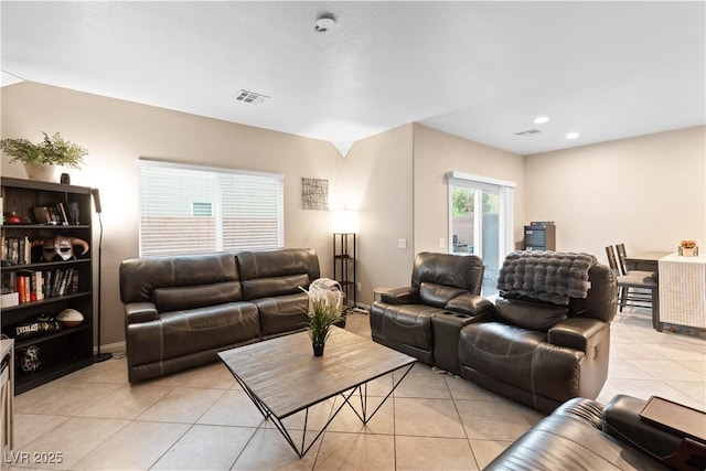 living area with light tile patterned floors, visible vents, and recessed lighting