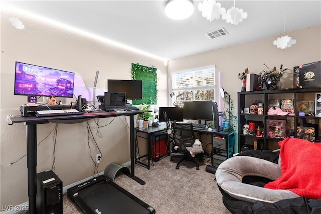 home office with visible vents, a notable chandelier, and light carpet