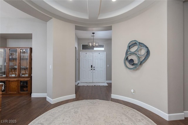 entrance foyer with dark wood-type flooring and baseboards