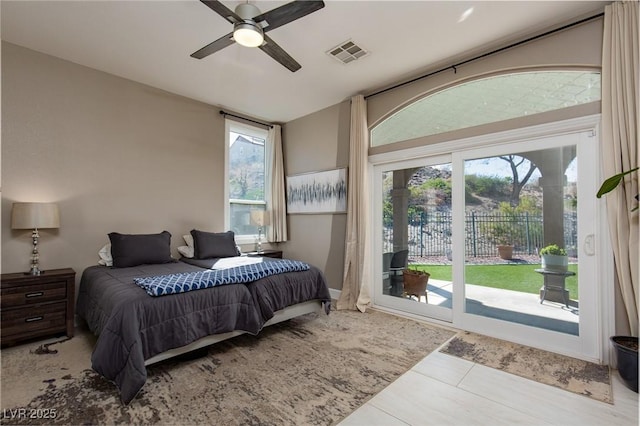 tiled bedroom featuring access to outside, visible vents, and ceiling fan