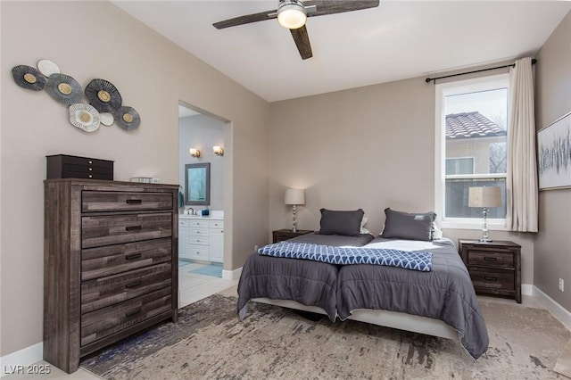 bedroom featuring ceiling fan, connected bathroom, and baseboards