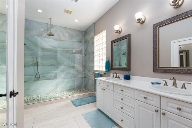 full bath featuring a walk in shower, double vanity, a sink, and visible vents