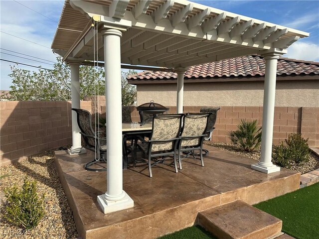 view of patio / terrace with outdoor dining space, a pergola, and fence