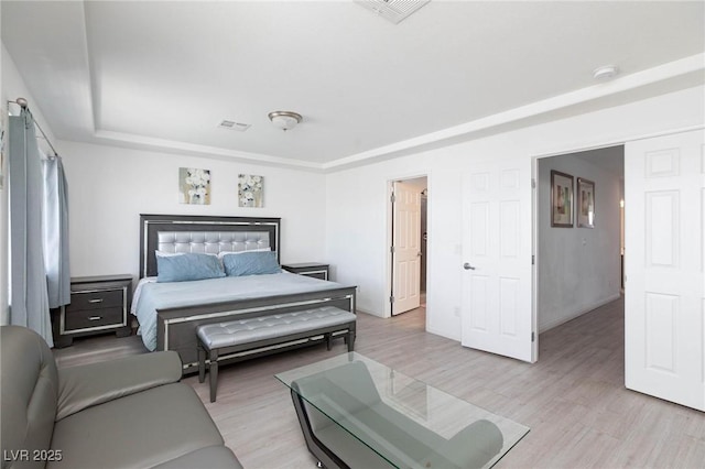 bedroom with visible vents and light wood-style flooring