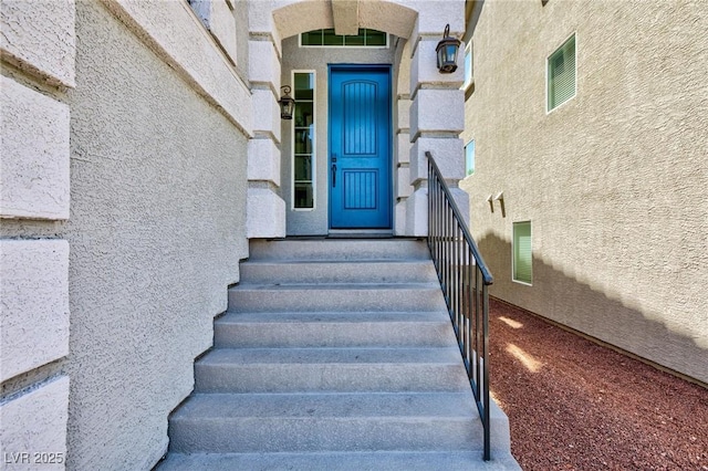 view of exterior entry with stucco siding