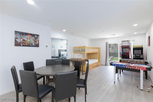 dining room featuring baseboards, light wood-style flooring, and recessed lighting