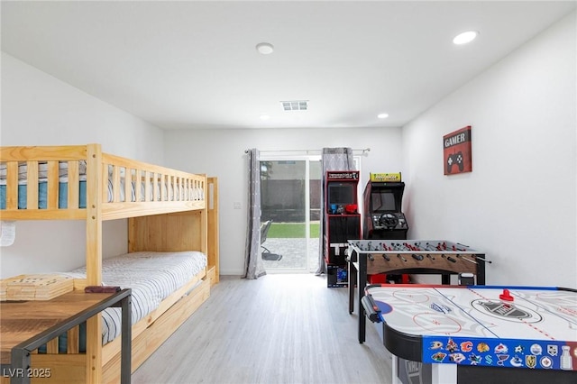 bedroom featuring access to outside, visible vents, light wood-style flooring, and recessed lighting