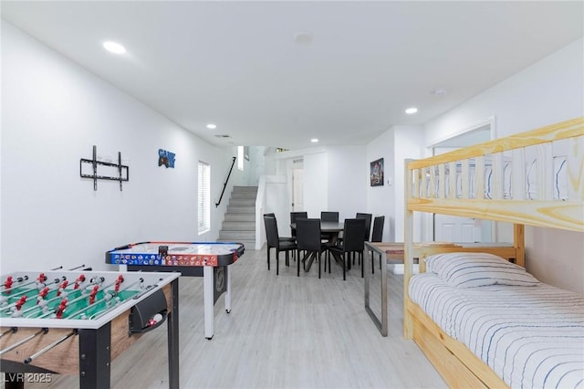 recreation room with wood finished floors and recessed lighting