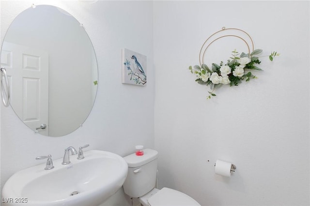 bathroom featuring toilet and a sink