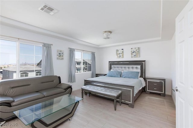 bedroom featuring light wood finished floors and visible vents