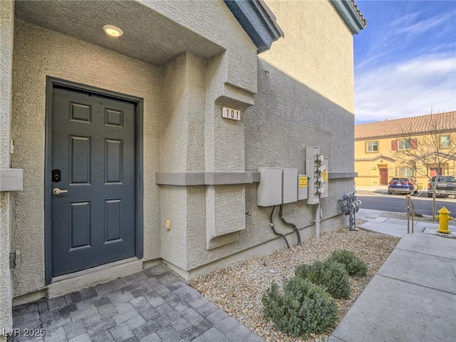 entrance to property with stucco siding