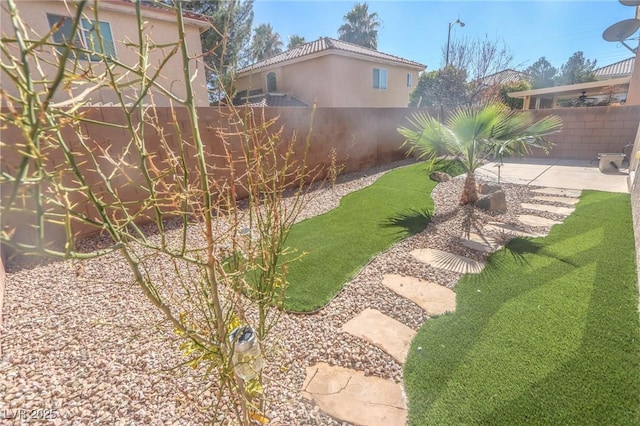 view of yard featuring a patio area and a fenced backyard