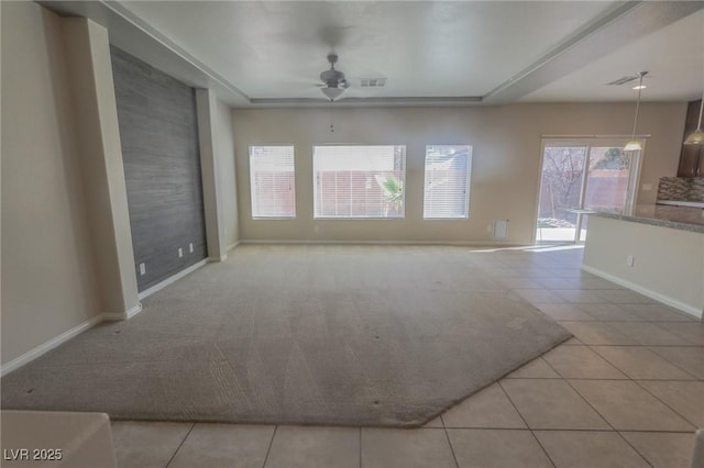 unfurnished living room featuring light tile patterned floors, visible vents, baseboards, and ceiling fan