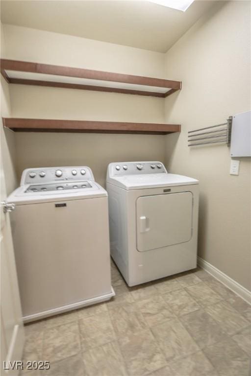 clothes washing area featuring washer and dryer, laundry area, baseboards, and light floors