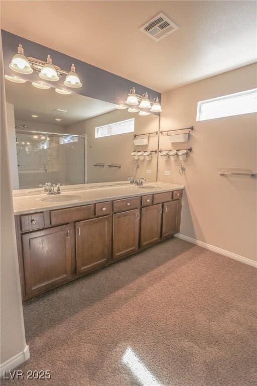 bathroom with carpet, visible vents, a sink, and a shower with shower door