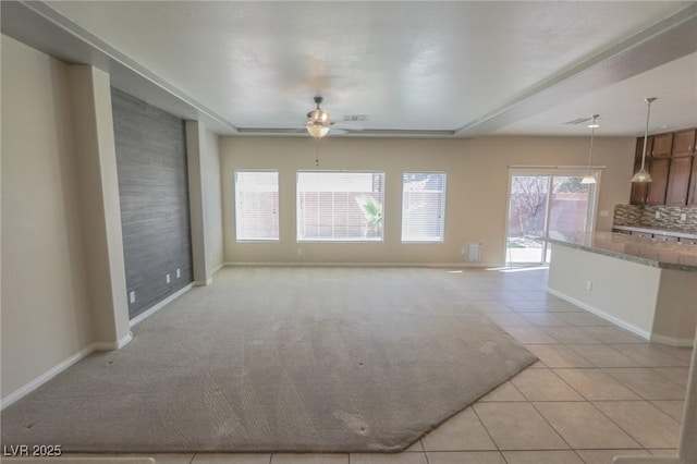 unfurnished living room featuring visible vents, baseboards, a ceiling fan, and light tile patterned flooring