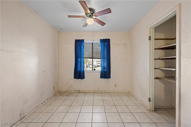 unfurnished room with light tile patterned flooring and a ceiling fan