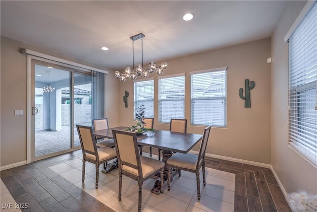 dining room with baseboards, a notable chandelier, wood finished floors, and recessed lighting