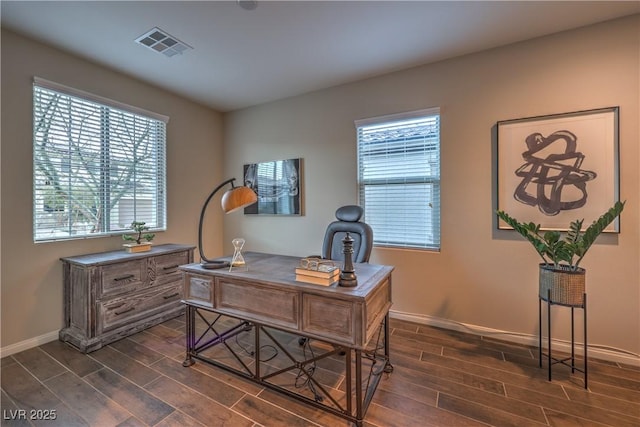 home office featuring wood tiled floor, visible vents, baseboards, and a healthy amount of sunlight