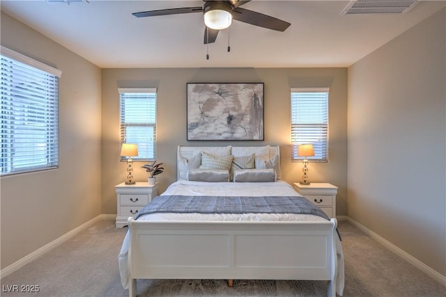 carpeted bedroom with baseboards, multiple windows, and visible vents