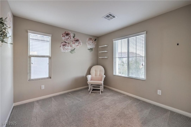 unfurnished room featuring carpet floors, a wealth of natural light, baseboards, and visible vents