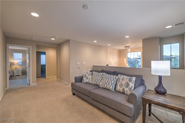 living room featuring baseboards, visible vents, and recessed lighting