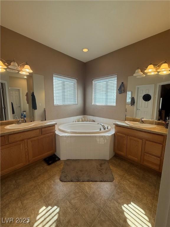 full bath with vaulted ceiling, two vanities, a sink, and a bath