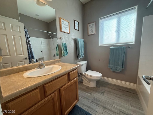 bathroom with baseboards, toilet, vanity, shower / bath combination with curtain, and wood finish floors