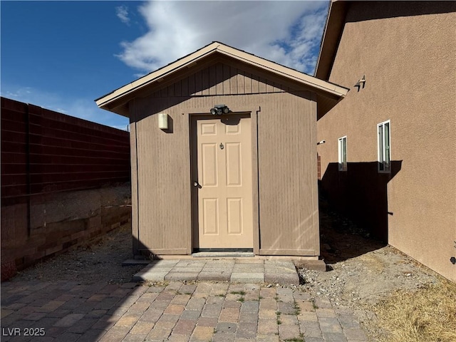 view of shed with fence